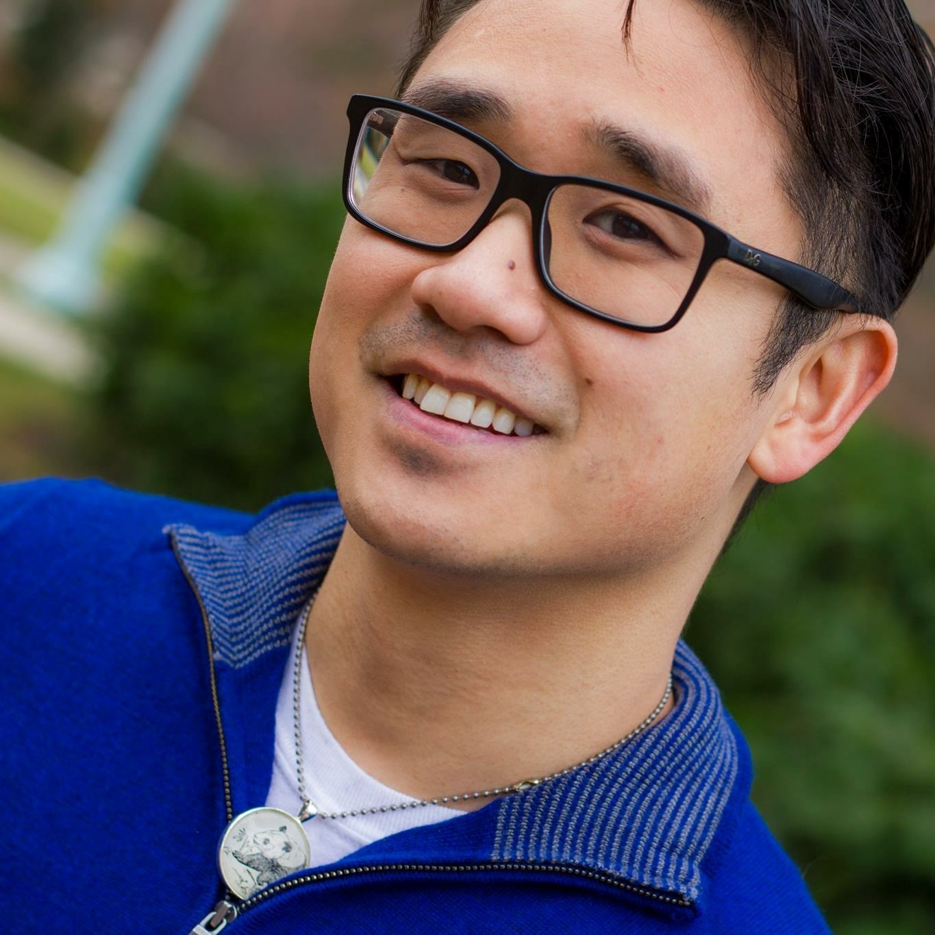 Photo of an Asian male in a sweater
